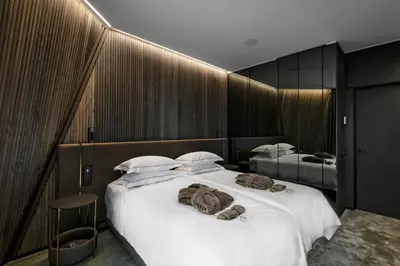 a bedroom with a large bed with towels on it at Mana Sleep & Spa in Druskininkai