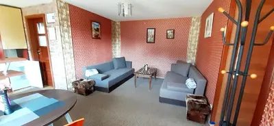 a living room with two blue couches and a table at Viešnagė pas Valentiną in Sužionys