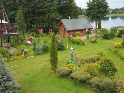 an aerial view of a garden with a wooden house at Viešnagė pas Valentiną in Sužionys