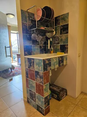 a kitchen with colorful tiles on the wall at Barrister's apartments with fireplace in Šiauliai