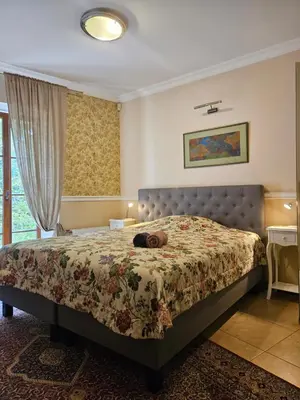 a bedroom with a bed with a stuffed animal on it at Barrister's apartments with fireplace in Šiauliai