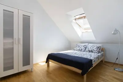 a bedroom with a bed and a skylight at PRIVATE FREE SAUNA & 4 bedrooms Old Town Rooftop Apartment in Vilnius