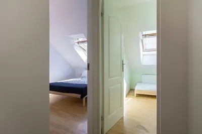 an open door to a room with a bed at PRIVATE FREE SAUNA & 4 bedrooms Old Town Rooftop Apartment in Vilnius