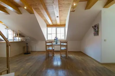 a room with a table and chairs in a attic at PRIVATE FREE SAUNA & 4 bedrooms Old Town Rooftop Apartment in Vilnius