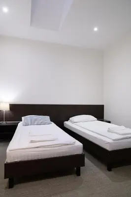 two beds sitting next to each other in a room at Jundula in Šakiai