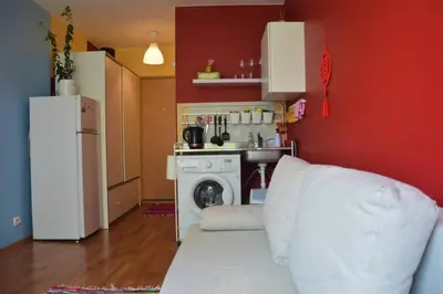 a kitchen with a white refrigerator and a washing machine at Slucko Central Studio Apartment near River in Vilnius