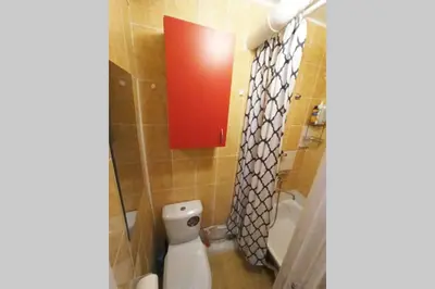 a small bathroom with a toilet and a shower at 9th floor Amazing View Central Studio Apartment in Vilnius