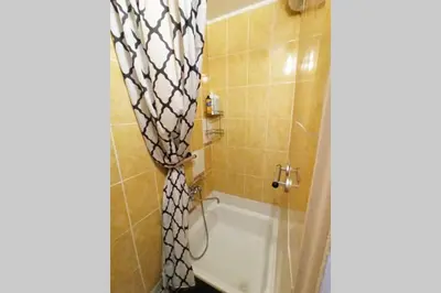 a bathroom with a shower with a shower curtain at 9th floor Amazing View Central Studio Apartment in Vilnius