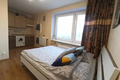 a bedroom with a bed with pillows and a window at 9th floor Amazing View Central Studio Apartment in Vilnius