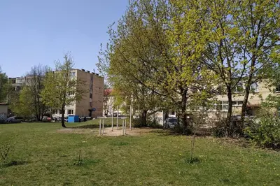 a park with a swing set in the grass at 9th floor Amazing View Central Studio Apartment in Vilnius