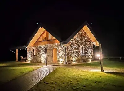a stone building with lights on it at night at Stone house in Prapuntai