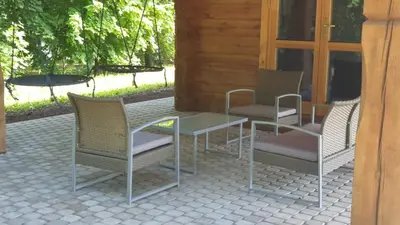 three chairs and a table on a patio at Stone house in Prapuntai