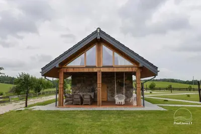 a gazebo in a field with chairs at Stone house in Prapuntai