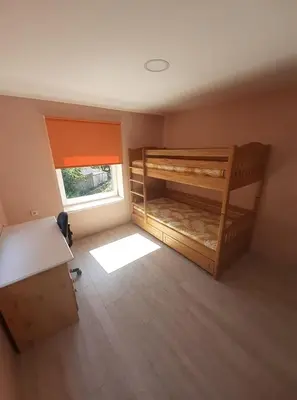 a room with two bunk beds and a window at VĖJO16 in Biržai
