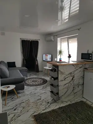 a living room with a couch and a table at Butas Senamiestyje Vytauto 7-4 in Rokiškis