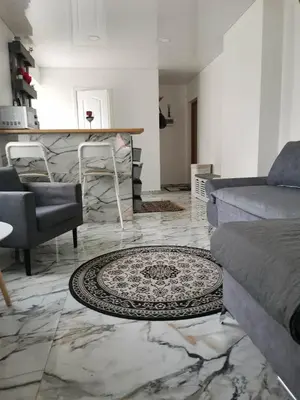 a living room with a couch and a table at Butas Senamiestyje Vytauto 7-4 in Rokiškis