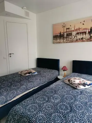two beds sitting next to each other in a bedroom at Butas Senamiestyje Vytauto 7-4 in Rokiškis