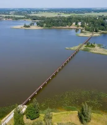 an aerial view of a bridge over a lake at VĖJO16 in Biržai