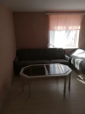 a living room with a couch and a coffee table at VĖJO16 in Biržai