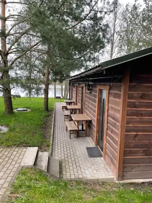 a picnic table and benches in a park at Atostogų būstas in Kurėnai