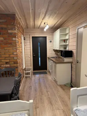 a room with a kitchen and a black door at Atostogų būstas in Kurėnai