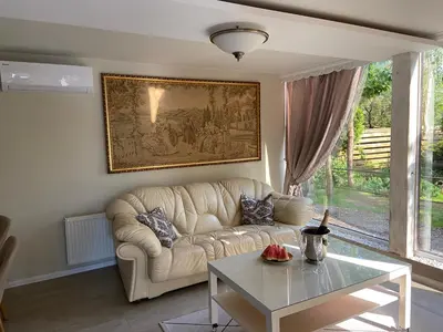 a living room with a couch and a table at Cosy and peaceful apartment in Kaunas