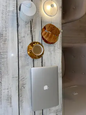 a laptop computer sitting on top of a table at Cosy and peaceful apartment in Kaunas