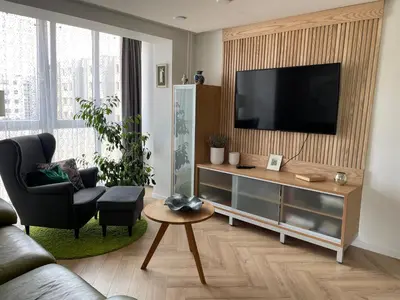 a living room with a flat screen tv on a wall at Lake apartaments in Ignalina