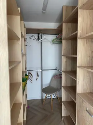 a walk in closet with a chair in the middle at Lake apartaments in Ignalina