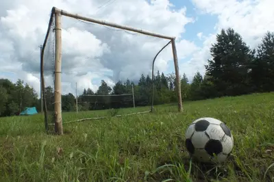 a soccer ball in a field with a goal at Sodyba Basapėdė in Bijutiškis