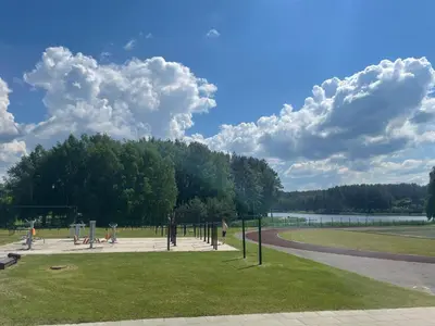 a park with a bunch of playground equipment in the grass at Holiday Apartments 10 in Druskininkai