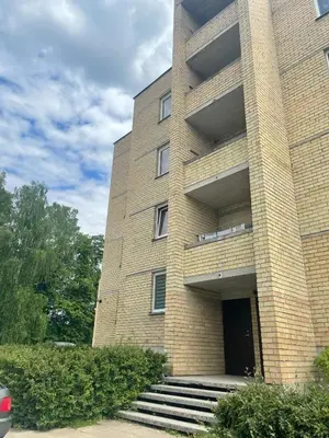 a brick building with stairs in front of it at Holiday Apartments 10 in Druskininkai