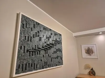 a painting hanging on a wall in a room at Holiday Apartments 10 in Druskininkai