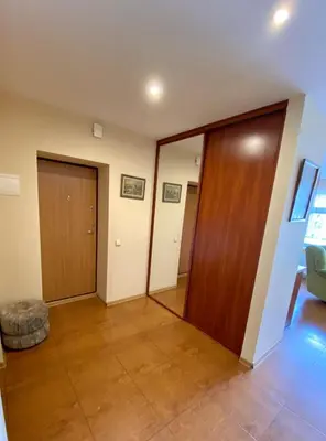 a living room with two doors and a hallway at Apartamentai Vytauto 16 in Druskininkai