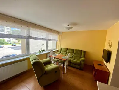 a living room with a couch and chairs and a table at Apartamentai Vytauto 16 in Druskininkai