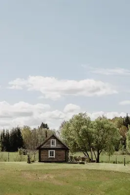 an old house in the middle of a field at Vienkiemio Oazė - Pasakų namelis in Galvokai
