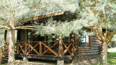 a log cabin with a fence in front of it at Šeimyninis namelis nr.1 in Kurėnai
