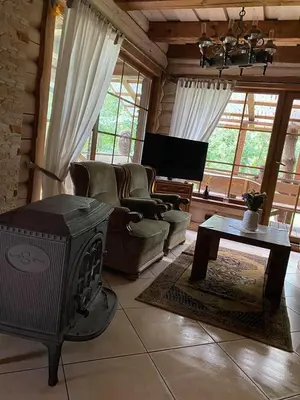 a living room with a couch and a fireplace at Šeimyninis namelis nr.2 in Kurėnai