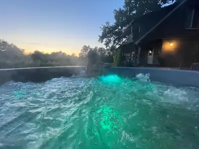 a swimming pool with blue lights in the water at Namelis prie Širvintos upės su pirtimi in Širvintos