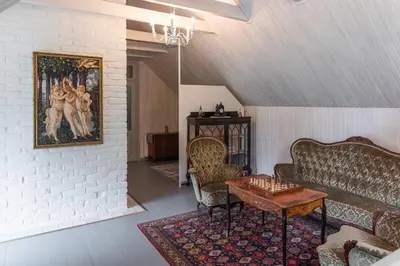 a living room with a couch and a table at Namelis prie Širvintos upės su pirtimi in Širvintos