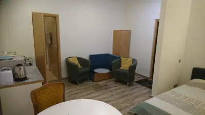 a small room with two chairs and a bed at Laisvės 50D in Kaunas