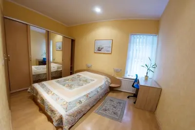 a bedroom with a large bed and a window at Laisvės 50D in Kaunas