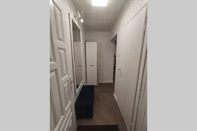 an empty hallway with a hallway leading to a door at Cozy stay in unique town - Kėdainiai in Kėdainiai