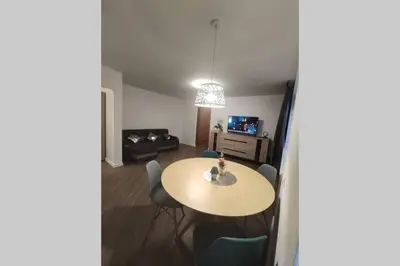 a living room with a table and chairs at Cozy stay in unique town - Kėdainiai in Kėdainiai