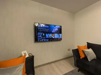 a living room with a flat screen tv on the wall at Comfy 2 Room Apartment - Free Parking - 350Mbps WiFi - Netflix in Kaunas