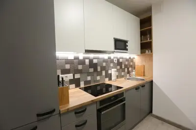 a kitchen with a sink and a counter at Comfy 2 Room Apartment - Free Parking - 350Mbps WiFi - Netflix in Kaunas