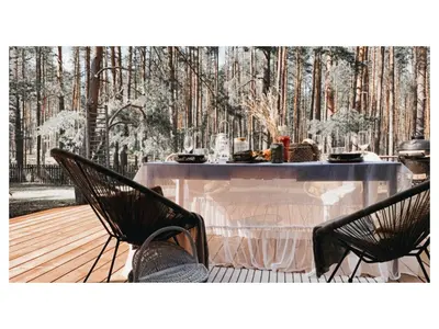 a table in the middle of a forest at Peledos troba in Žiūrai