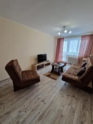 a living room with two chairs and a couch and a tv at Lima C in Druskininkai