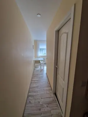 an empty hallway with a door and a table at Lima C in Druskininkai