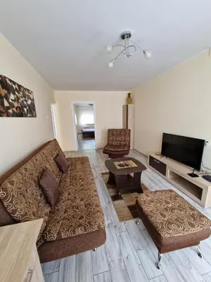 a living room with a couch and a tv at Lima C in Druskininkai